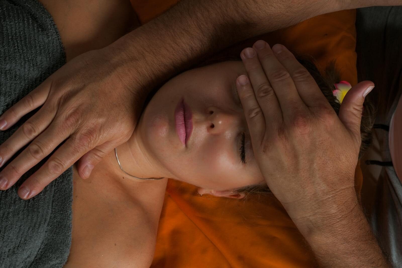 A serene close-up of a woman receiving a reiki massage for ultimate relaxation and wellness.